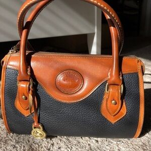 Dooney & Bourke Black and Brown Satchel with Structured Design